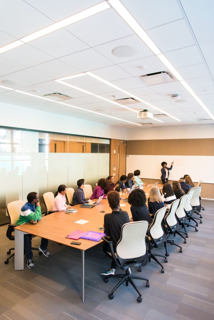 Two professionals in a meeting room discussion
