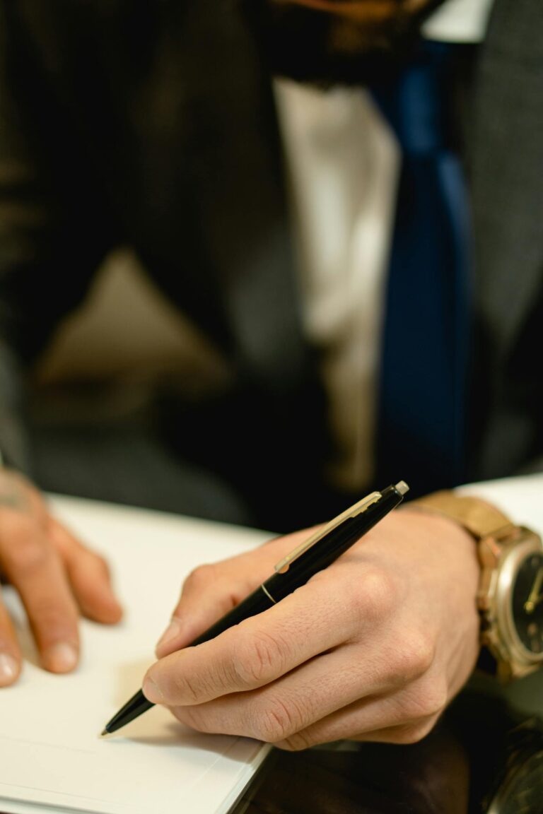 Hands signing a contract with a pen