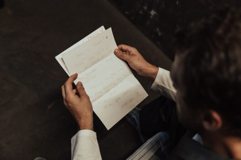 A person at a desk reading a letter
