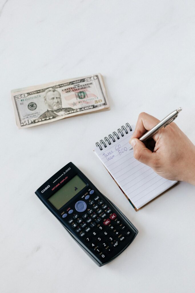 Invoices and a calculator on a desk