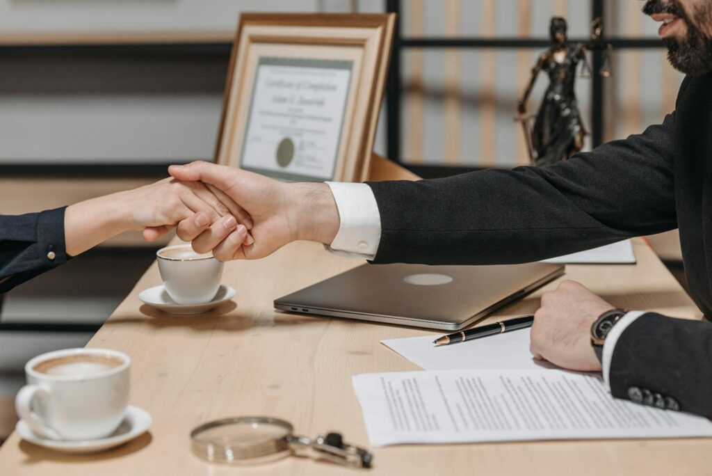 A business handshake over paperwork
